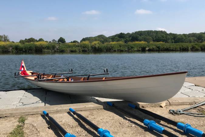 Tandem Wherry wooden rowing boat on the river Thames