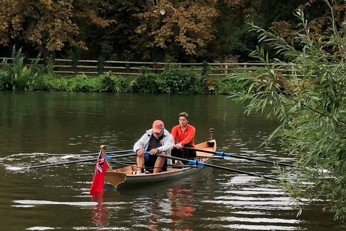 Tandem Wherry wooden rowing boat on the river Thames